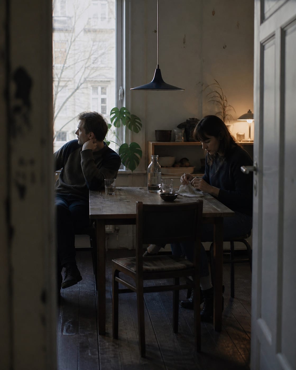 Editorial short-film concept of two people at a kitchen table.